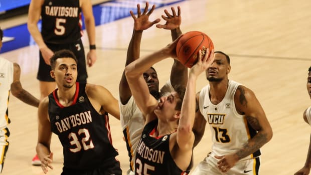 Mar 6, 2021; Richmond, Virginia, USA; Davidson Wildcats forward Luka Brajkovic (35) shoots the ball as VCU Rams forward Vince Williams Jr. (10) defends in the second half in a semifinal of the Atlantic 10 conference tournament at Stuart C. Siegel Center. Mandatory Credit: Geoff Burke-USA TODAY Sports